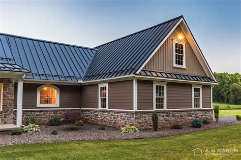 black metal roof on tan house|black and tan exterior house.